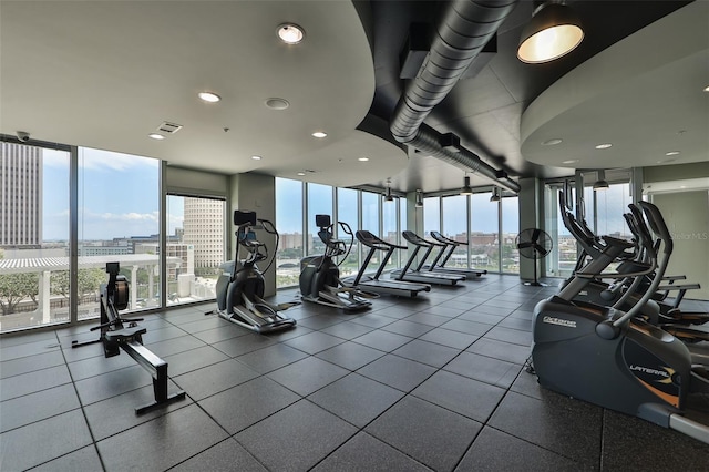 gym featuring visible vents and floor to ceiling windows