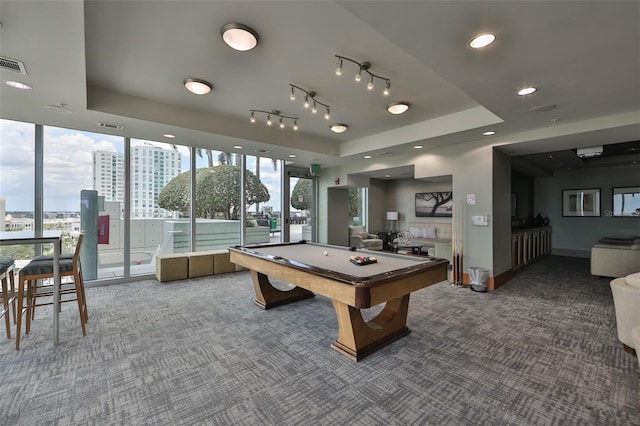 rec room featuring a raised ceiling, carpet flooring, a city view, and billiards