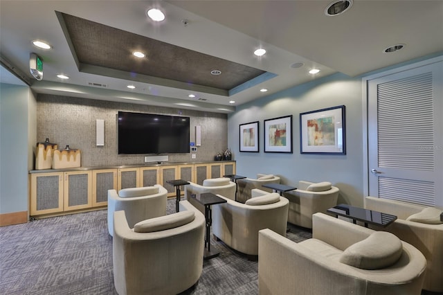 cinema room featuring a tray ceiling, carpet floors, visible vents, and recessed lighting