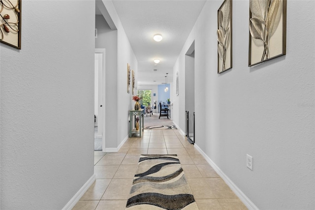 10626 Laguna Plains Dr, Riverview, FL 33578 - hallway featuring light tile patterned floors and baseboards