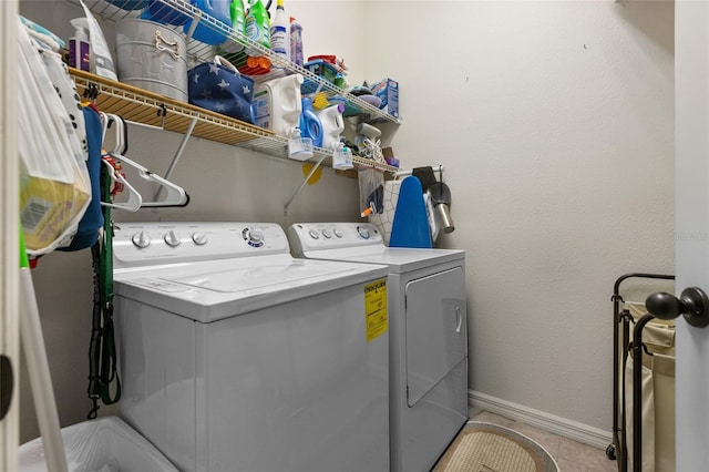 10626 Laguna Plains Dr, Riverview, FL 33578 - clothes washing area with washer and dryer, baseboards, and light tile patterned flooring