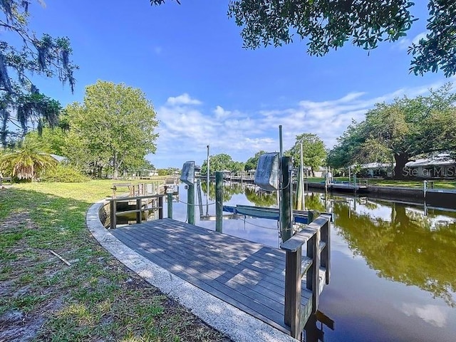 11473 W Sandpiper Ct, Crystal River, FL 34429 - dock featuring boat lift and a water view