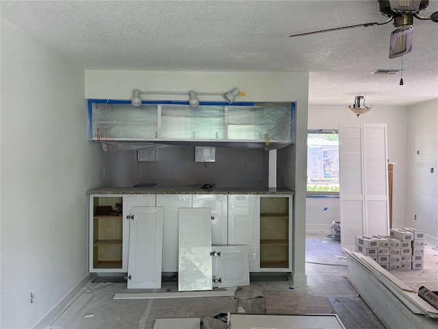 11473 W Sandpiper Ct, Crystal River, FL 34429 - kitchen with a textured ceiling, ceiling fan, and white cabinets
