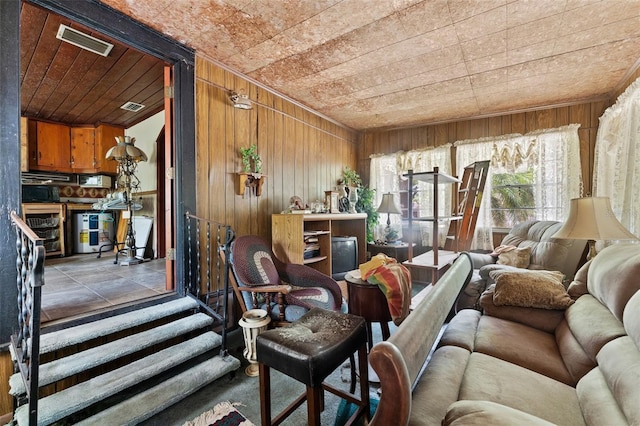 interior space with beverage cooler, wood ceiling, wooden walls, and visible vents