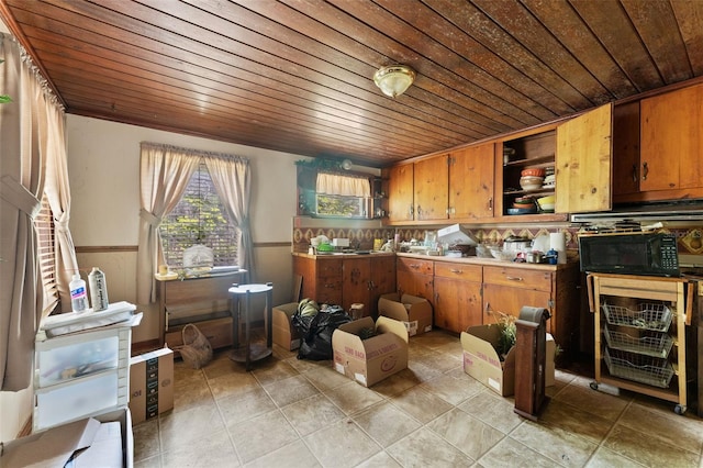 kitchen featuring brown cabinetry, black microwave, open shelves, and wooden ceiling