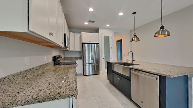 20092 Stone Pine Cir, Lutz, FL 33558 - kitchen with stainless steel appliances, a sink, light marble finish flooring, a center island with sink, and white cabinetry