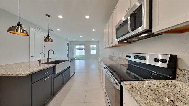 20092 Stone Pine Cir, Lutz, FL 33558 - kitchen featuring stainless steel appliances, a sink, white cabinets, recessed lighting, and an island with sink