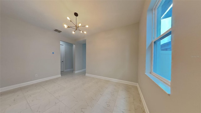 20092 Stone Pine Cir, Lutz, FL 33558 - spare room with a chandelier, light marble finish flooring, and baseboards