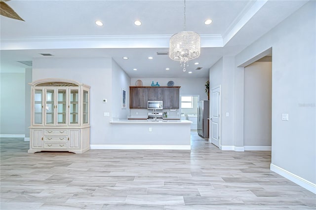 5732 Stockport St, Riverview, FL 33578 - kitchen featuring stainless steel appliances, recessed lighting, a chandelier, crown molding, and light countertops