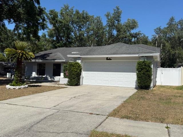 1710 Tallowtree Cir, Valrico, FL 33594 - ranch-style home featuring fence, an attached garage, and driveway