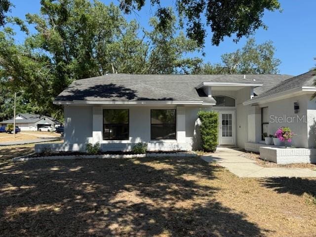 1710 Tallowtree Cir, Valrico, FL 33594 - rear view of house with stucco siding and roof with shingles