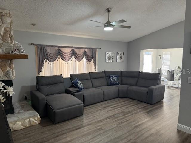 1710 Tallowtree Cir, Valrico, FL 33594 - living room with a textured ceiling, wood finished floors, a ceiling fan, and lofted ceiling