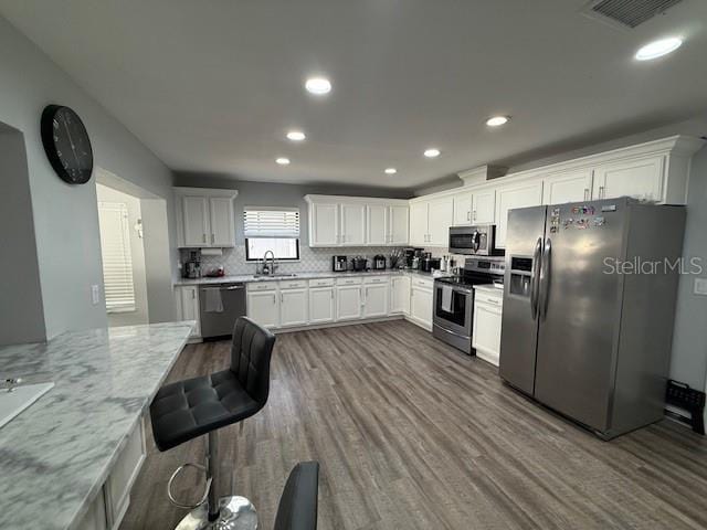 1710 Tallowtree Cir, Valrico, FL 33594 - kitchen featuring appliances with stainless steel finishes, visible vents, dark wood-style floors, and a sink