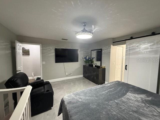 1710 Tallowtree Cir, Valrico, FL 33594 - bedroom featuring a barn door, baseboards, and visible vents