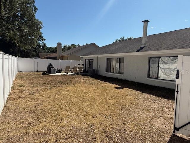 1710 Tallowtree Cir, Valrico, FL 33594 - back of house with a fenced backyard and a yard