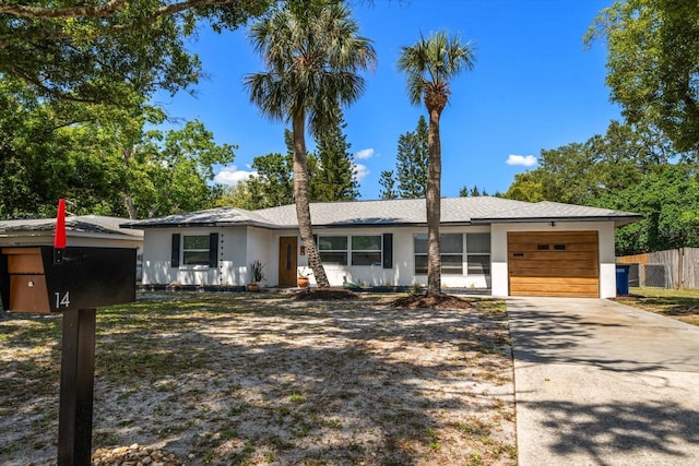 14 S Meteor Ave, Clearwater, FL 33765 - view of front of property with an attached garage, stucco siding, and driveway