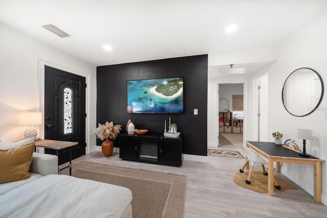 14 S Meteor Ave, Clearwater, FL 33765 - living area with light wood-type flooring, baseboards, an accent wall, and recessed lighting