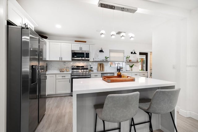 14 S Meteor Ave, Clearwater, FL 33765 - kitchen featuring appliances with stainless steel finishes, light wood-type flooring, and white cabinetry