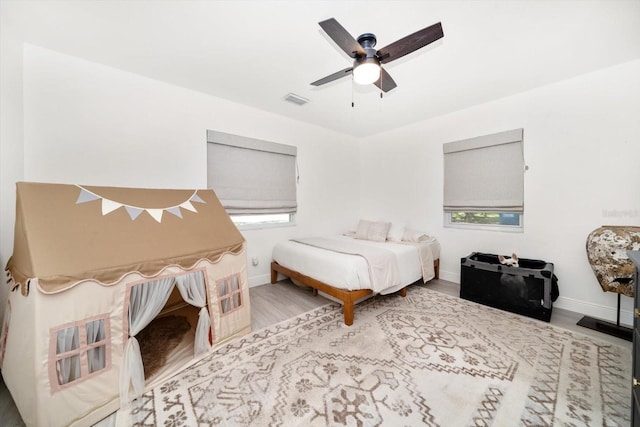 14 S Meteor Ave, Clearwater, FL 33765 - bedroom with wood finished floors, baseboards, and a ceiling fan
