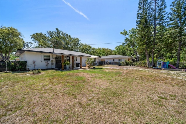 14 S Meteor Ave, Clearwater, FL 33765 - rear view of house with a playground and stucco siding