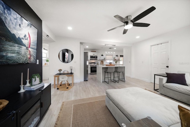14 S Meteor Ave, Clearwater, FL 33765 - living room with light wood-style floors, a ceiling fan, recessed lighting, and baseboards