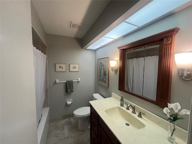 full bathroom with toilet, vanity, and baseboards