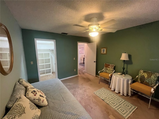bedroom featuring carpet floors, a textured ceiling, a ceiling fan, and baseboards