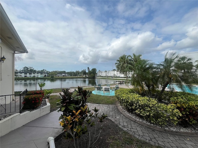 view of patio featuring a water view and an outdoor pool