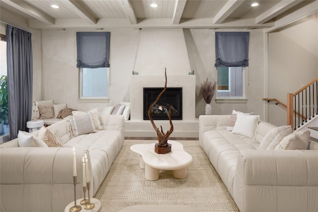 living area with a premium fireplace, beam ceiling, and recessed lighting