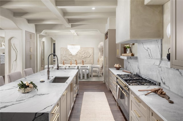 kitchen featuring stainless steel stove, beamed ceiling, backsplash, light stone counters, and dark wood-style floors