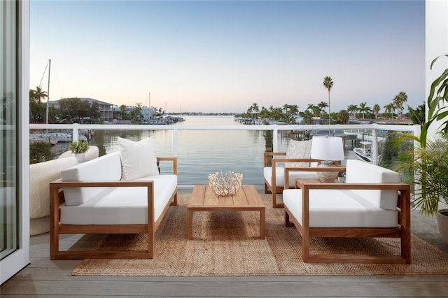 exterior space featuring a water view, outdoor lounge area, and a balcony