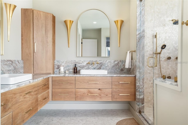 bathroom with walk in shower and vanity