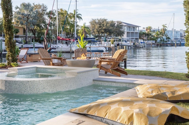 view of pool featuring a water view, a fire pit, a pool with connected hot tub, and a boat dock