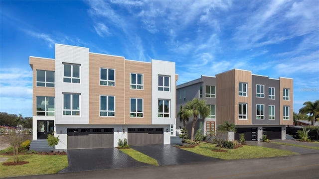 view of building exterior with driveway and a garage