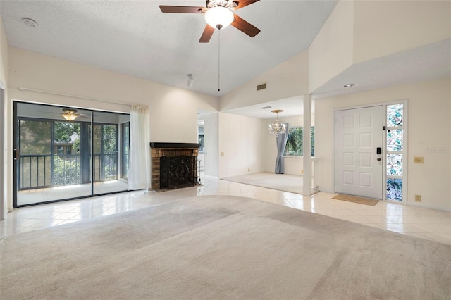 3066 Landmark Blvd Unit 1305, Palm Harbor, FL 34684 - unfurnished living room with tile patterned floors, carpet flooring, plenty of natural light, a fireplace, and high vaulted ceiling