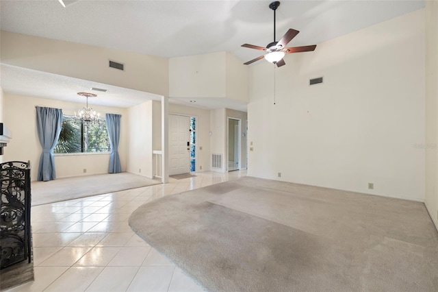 3066 Landmark Blvd Unit 1305, Palm Harbor, FL 34684 - unfurnished living room with a chandelier, light tile patterned floors, light carpet, ceiling fan, and high vaulted ceiling