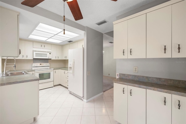 3066 Landmark Blvd Unit 1305, Palm Harbor, FL 34684 - kitchen featuring white appliances, a sink, ceiling fan, tasteful backsplash, and light tile patterned floors
