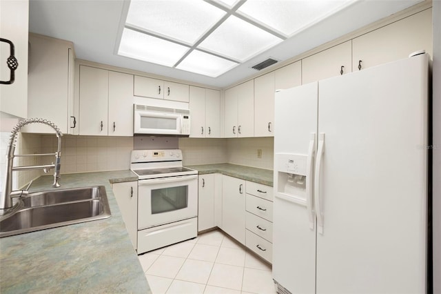 3066 Landmark Blvd Unit 1305, Palm Harbor, FL 34684 - kitchen featuring white appliances, a sink, decorative backsplash, and light tile patterned floors