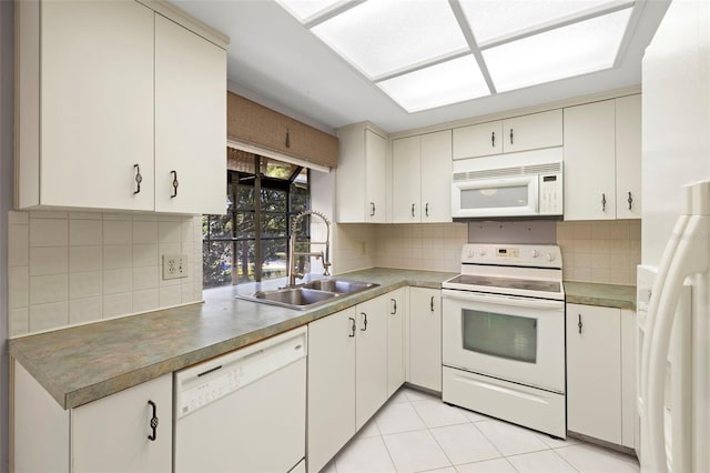 3066 Landmark Blvd Unit 1305, Palm Harbor, FL 34684 - kitchen featuring white appliances, a sink, decorative backsplash, and light tile patterned floors