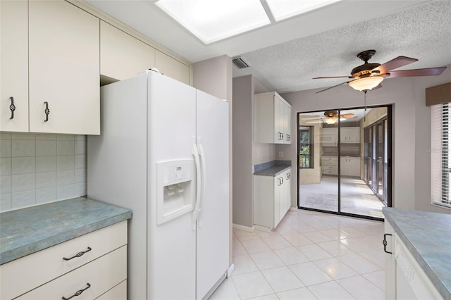 3066 Landmark Blvd Unit 1305, Palm Harbor, FL 34684 - kitchen featuring white fridge with ice dispenser, ceiling fan, tasteful backsplash, light tile patterned floors, and a textured ceiling