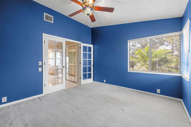 3066 Landmark Blvd Unit 1305, Palm Harbor, FL 34684 - carpeted empty room featuring french doors, a textured ceiling, ceiling fan, plenty of natural light, and baseboards