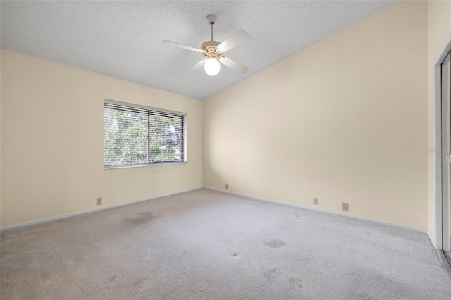 3066 Landmark Blvd Unit 1305, Palm Harbor, FL 34684 - spare room featuring carpet, vaulted ceiling, a ceiling fan, baseboards, and a textured ceiling