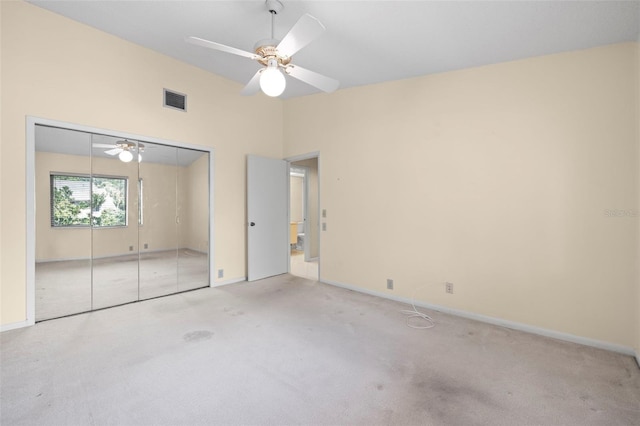 3066 Landmark Blvd Unit 1305, Palm Harbor, FL 34684 - unfurnished bedroom featuring carpet flooring, baseboards, a ceiling fan, and a closet