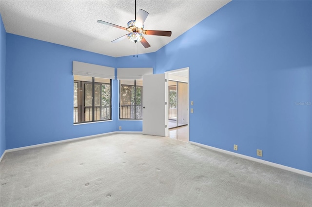 3066 Landmark Blvd Unit 1305, Palm Harbor, FL 34684 - unfurnished room featuring healthy amount of natural light, a ceiling fan, a textured ceiling, carpet flooring, and baseboards