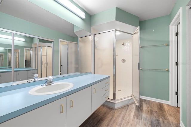 3066 Landmark Blvd Unit 1305, Palm Harbor, FL 34684 - bathroom with wood finished floors, vanity, and a shower stall