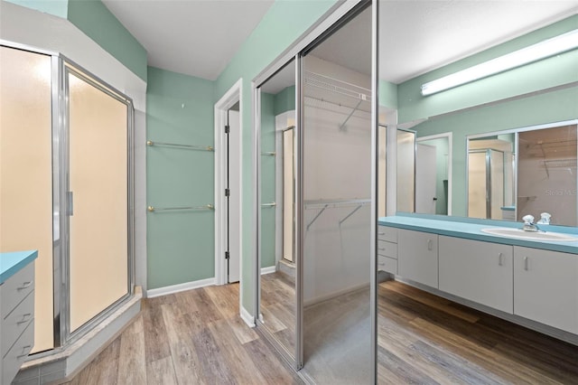 3066 Landmark Blvd Unit 1305, Palm Harbor, FL 34684 - full bath with vanity, wood finished floors, a walk in closet, and a shower stall