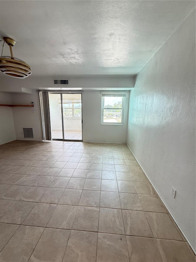 11447 Park Blvd Unit 301, Seminole, FL 33772 - tiled spare room featuring a textured wall and a textured ceiling