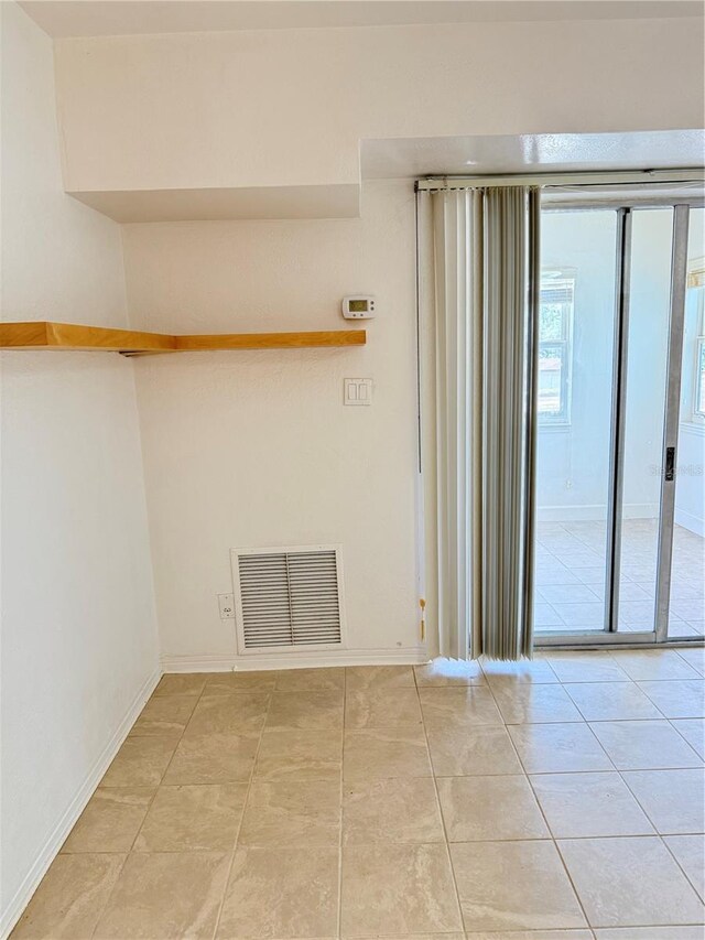 11447 Park Blvd Unit 301, Seminole, FL 33772 - unfurnished room with light tile patterned flooring and baseboards