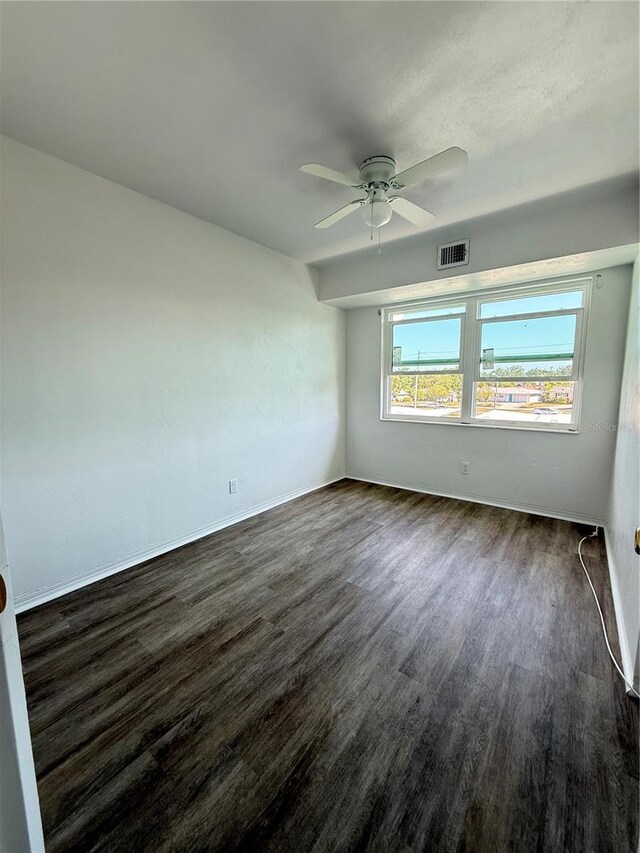 11447 Park Blvd Unit 301, Seminole, FL 33772 - empty room with ceiling fan, dark wood finished floors, and baseboards