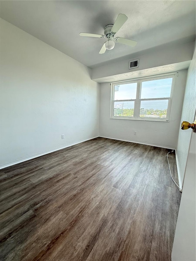 11447 Park Blvd Unit 301, Seminole, FL 33772 - spare room featuring dark wood-style floors, a ceiling fan, and baseboards